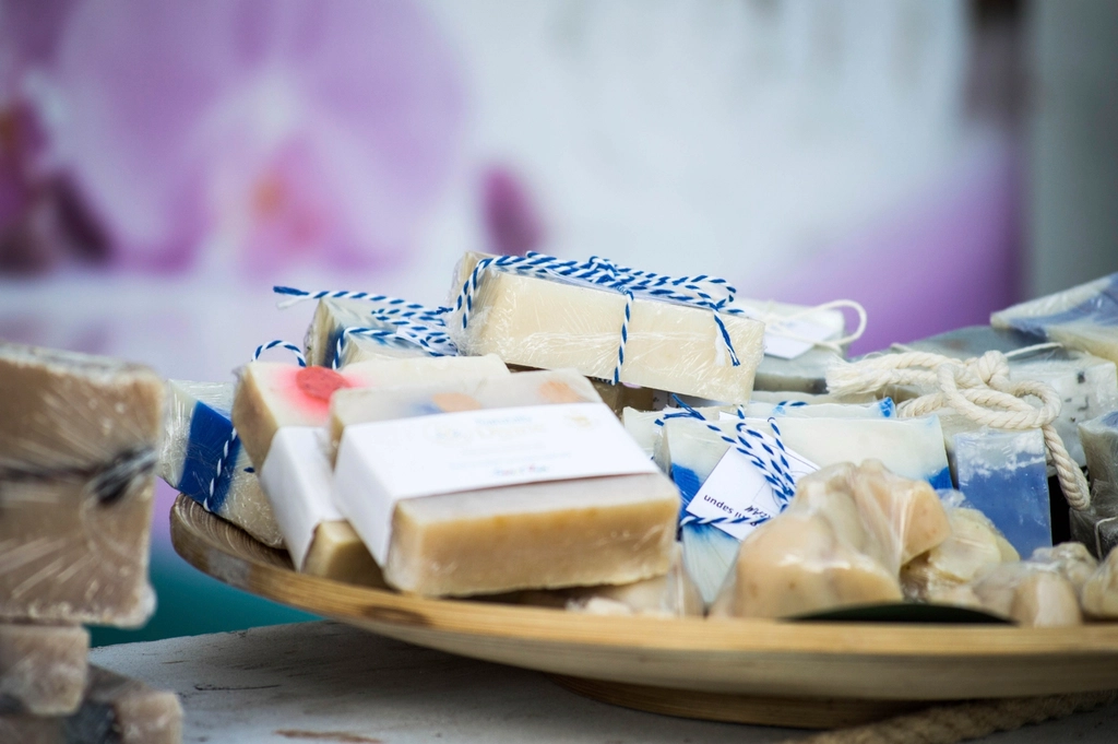 Bars of handmade soap wrapped with twine on a wooden platter