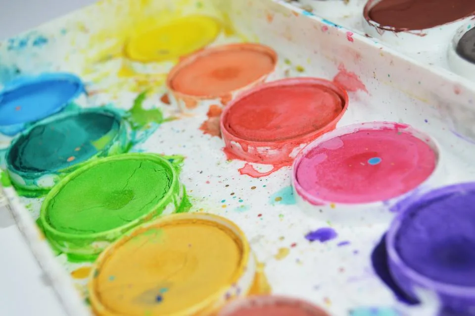 A watercolor paint palette with bright colors