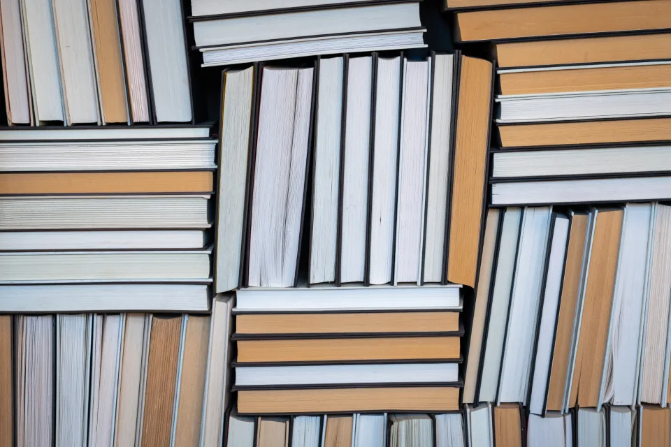 Stacks of used books with cream-colored page edges