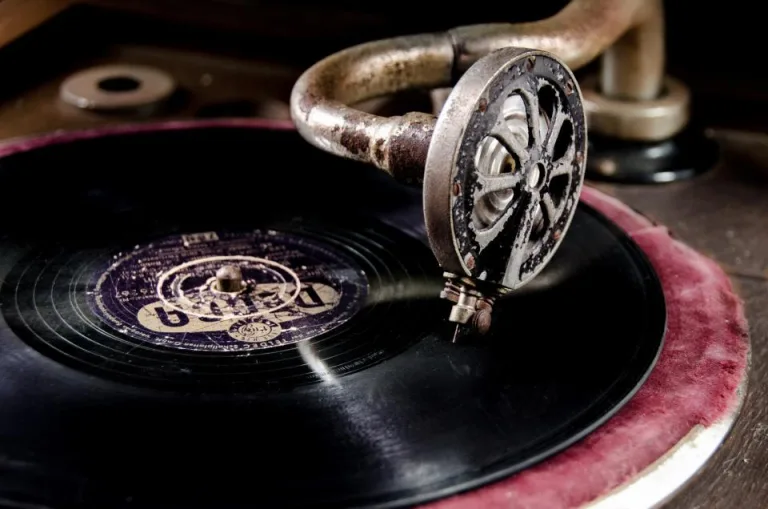 Close-up of an old gramophone needle resting on a vintage record