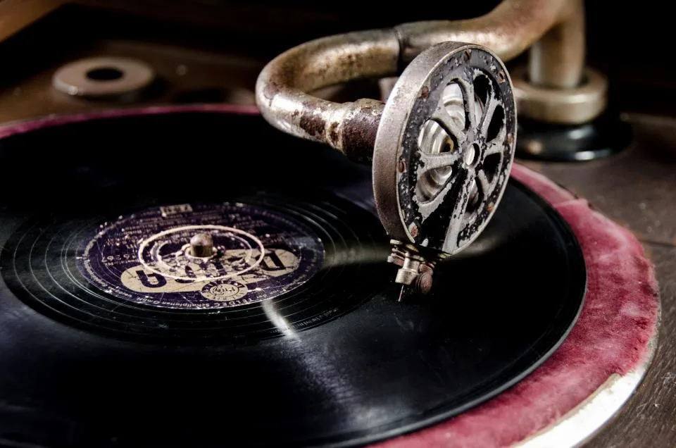 Close-up of an old gramophone needle resting on a vintage record